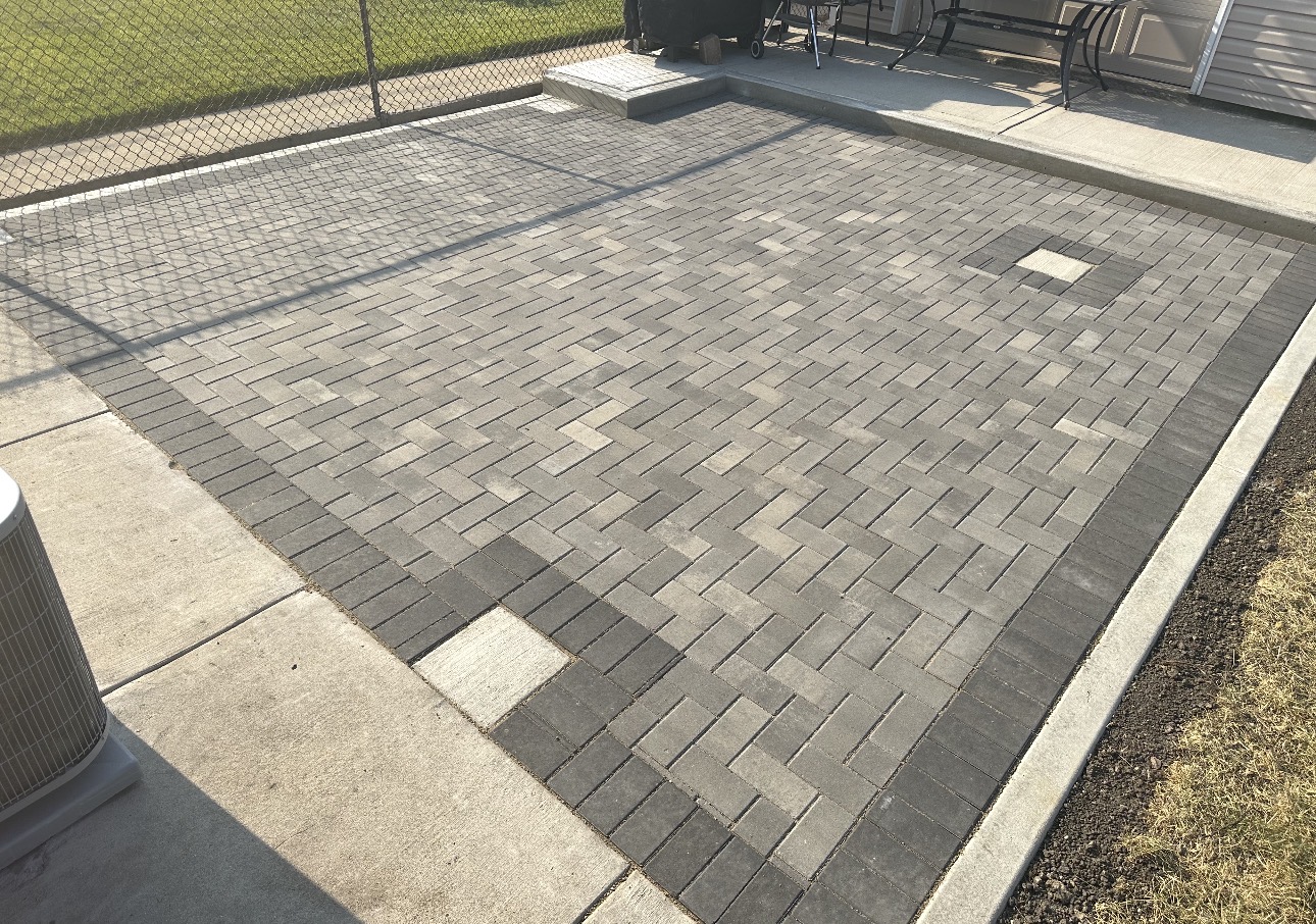 Finished herringbone paver patio in Chicago backyard